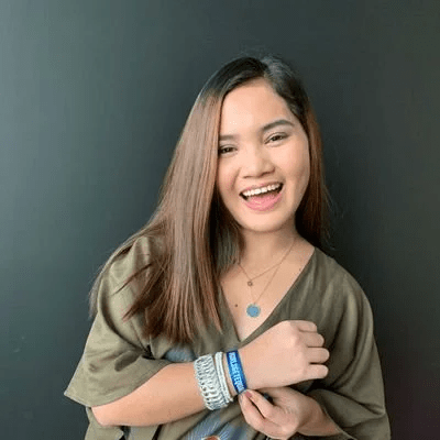 A youth smiles at the camera.