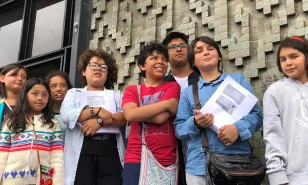 8 youth stand arms crossed.