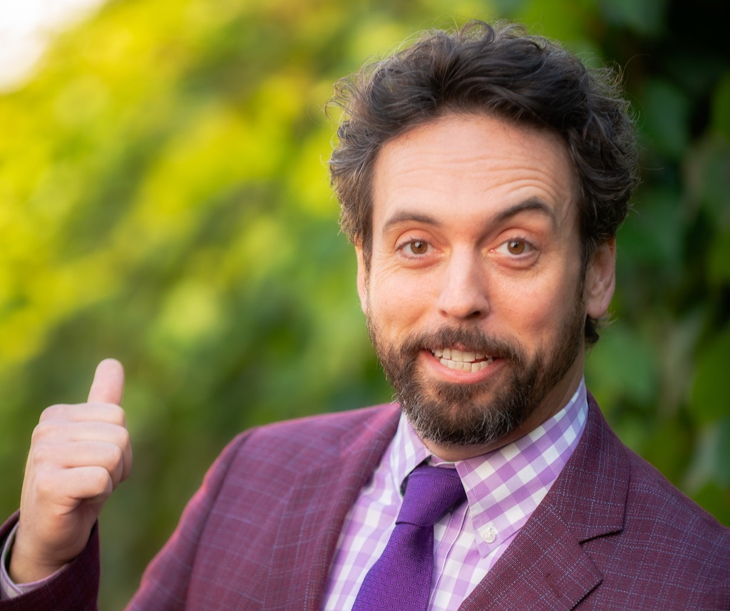 A man with short brown hair and a beard