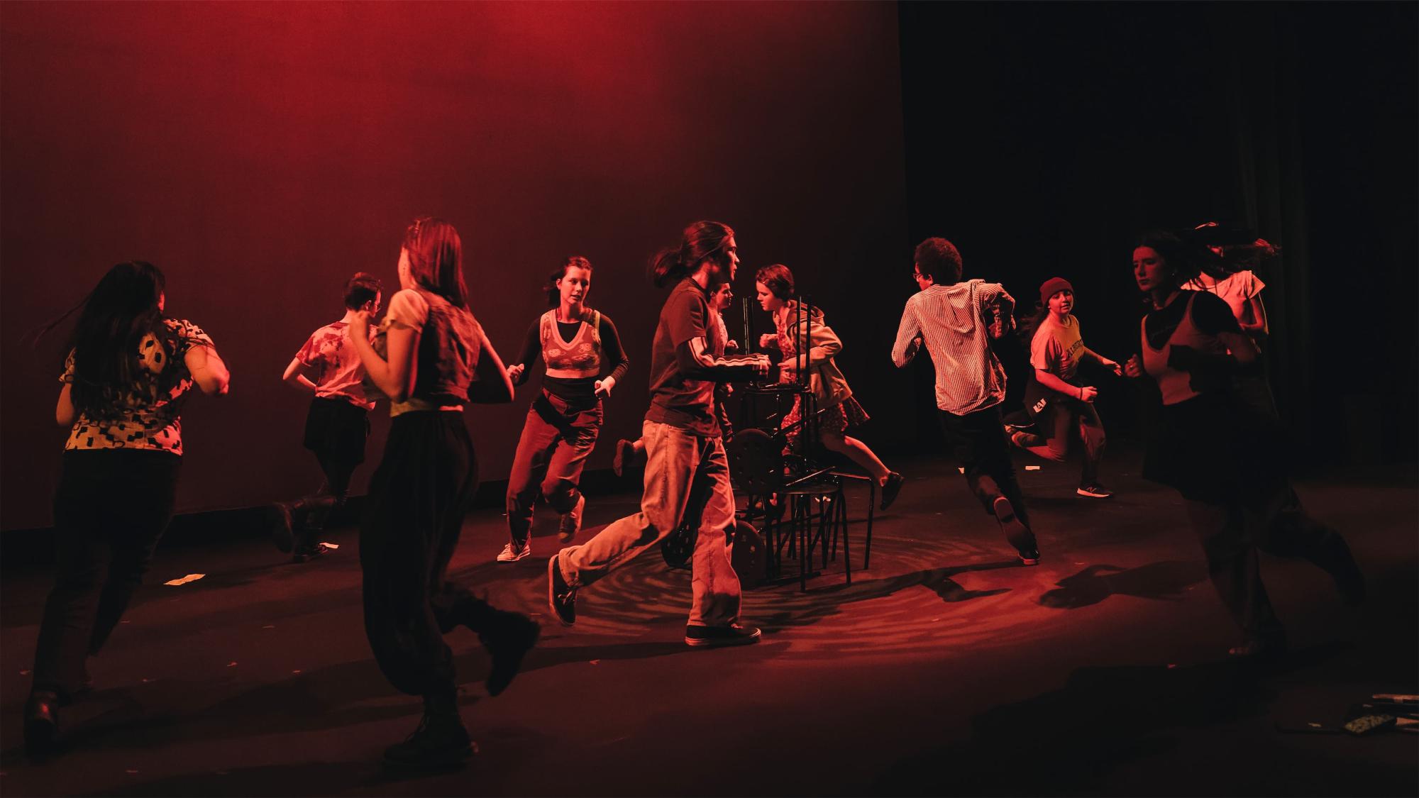youth running in a circle in red light